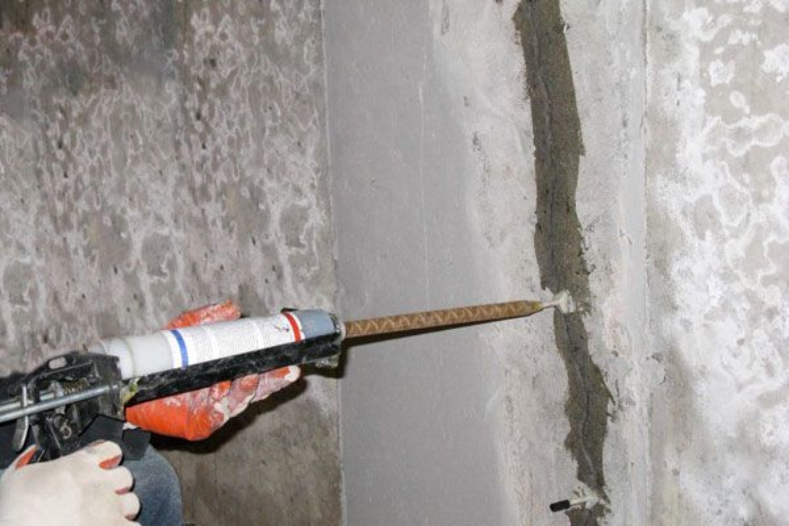 Injection grouting being applied into a concrete crack